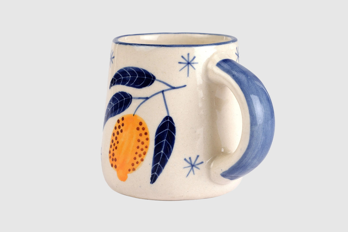 Ceramic mug with decorative elements on a white background