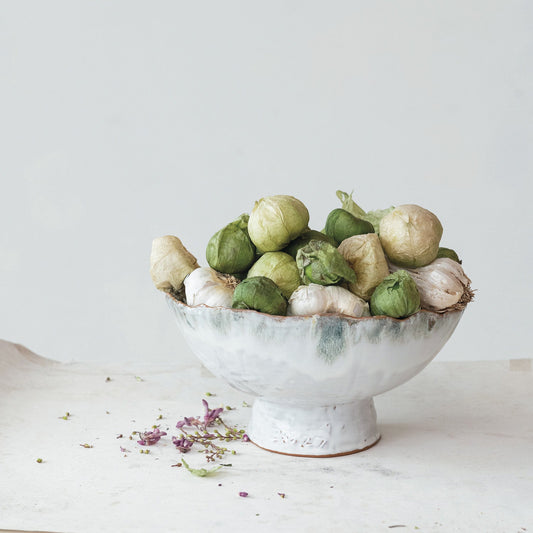 Bowl with green and white vegetables on a light background