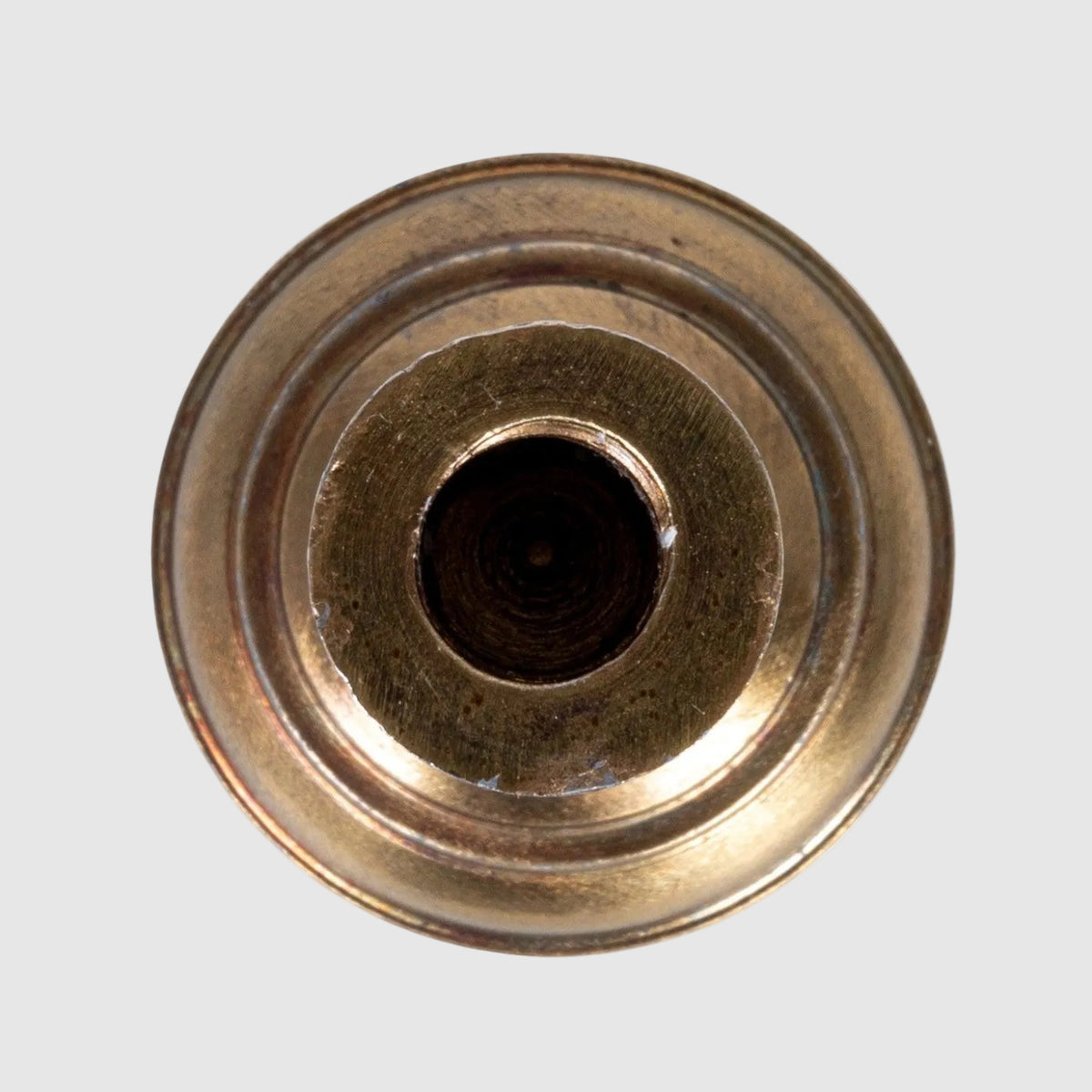 Bronze valve stem cap on a white background