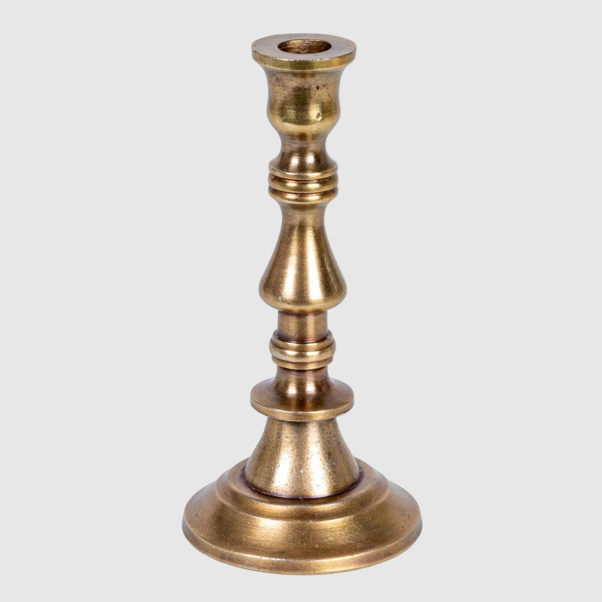 Brass candle holder on a white background