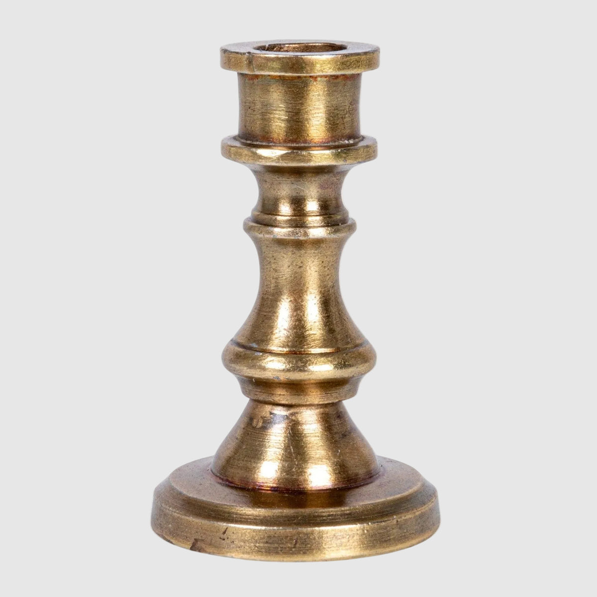 Brass candle holder on a white background