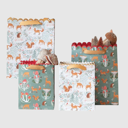 Set of three decorative paper bags with forest animal patterns on a white background
